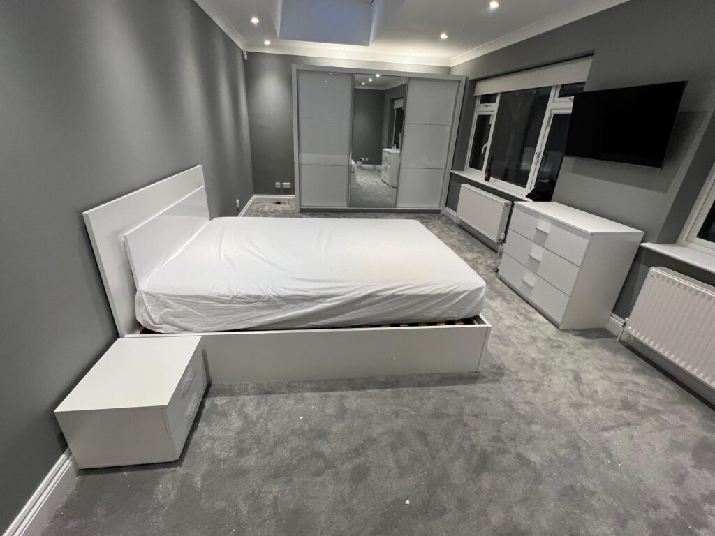 Fitted bedroom furniture with a wall-mounted television, assembled and installed